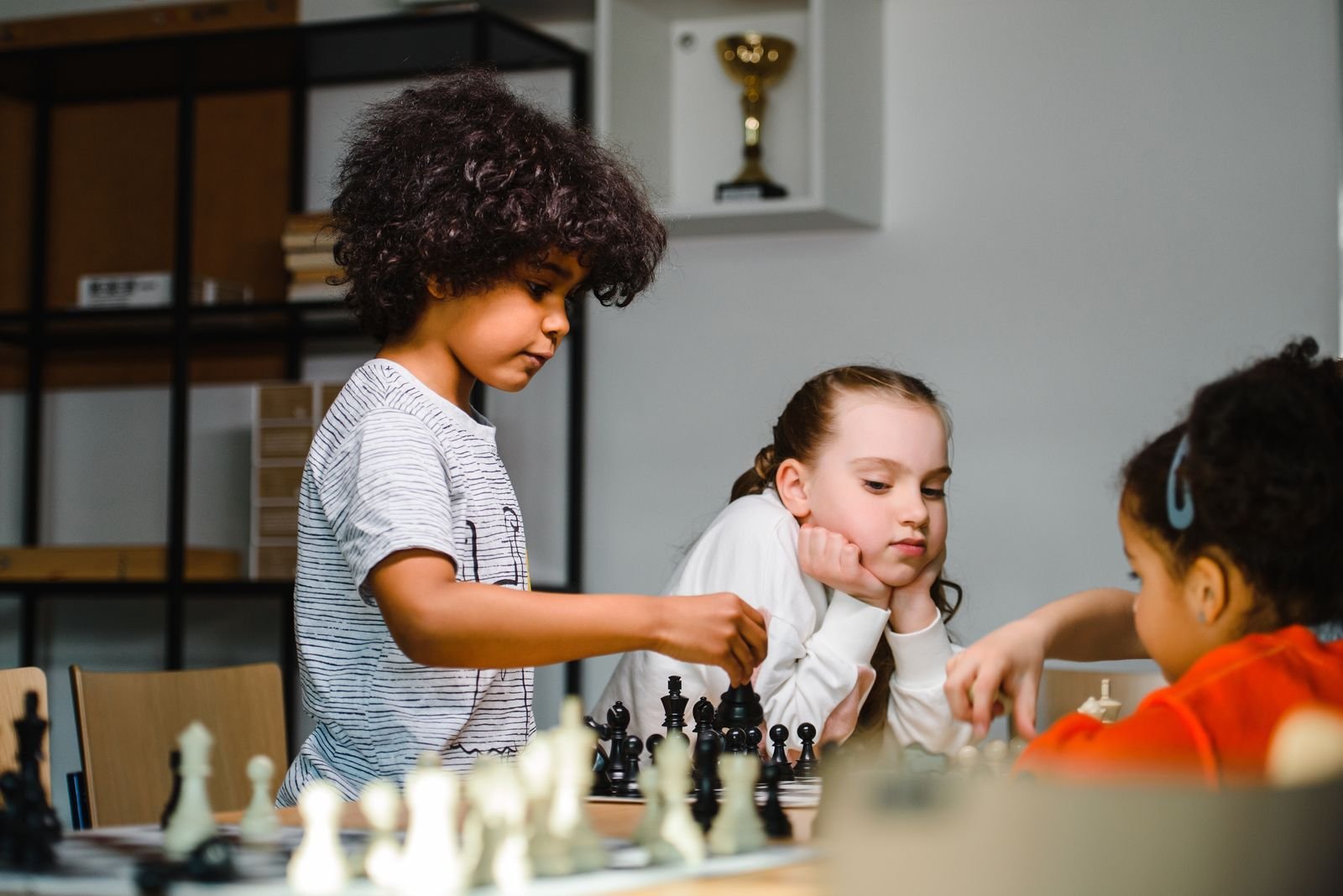 Children playing chess together at a PCR Inc. community chess session in Boston