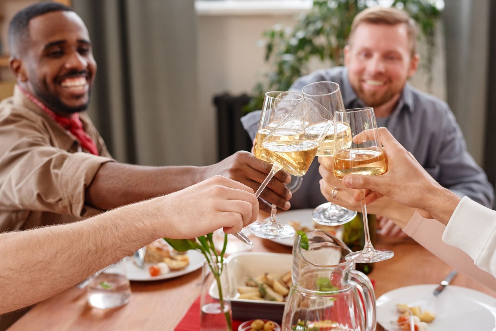 Guests raising a toast together over dinner at a community fundraising evening